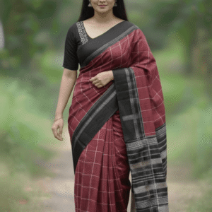 Woman wearing a maroon checkered handloom cotton saree with a black border.