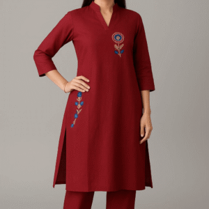 Women's maroon straight-cut cotton kurta with blue floral embroidery and matching trousers.